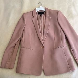 Woman 2 piece salmon color business suit.
